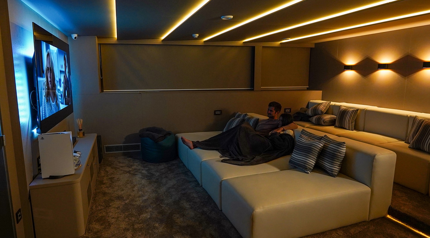 2 people watching a movie in the cinema room on the yacht