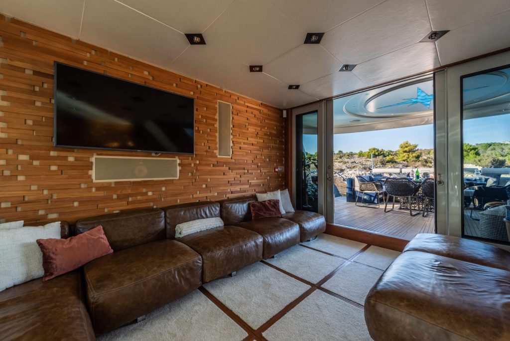 one blue yacht charter main saloon area with a tv