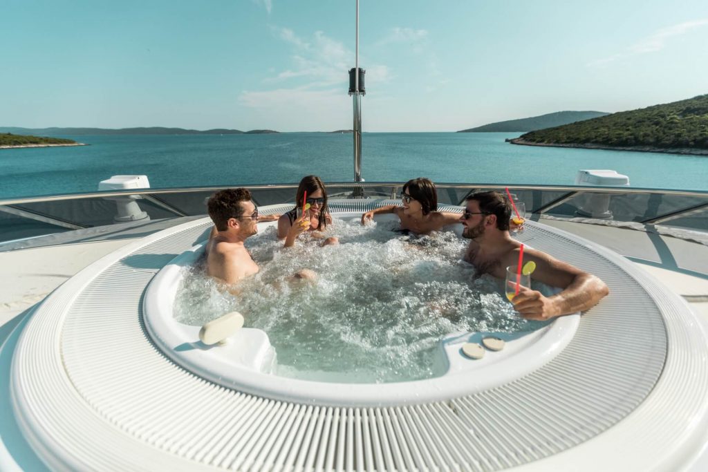 agram yacht charter guests in a jacuzzi