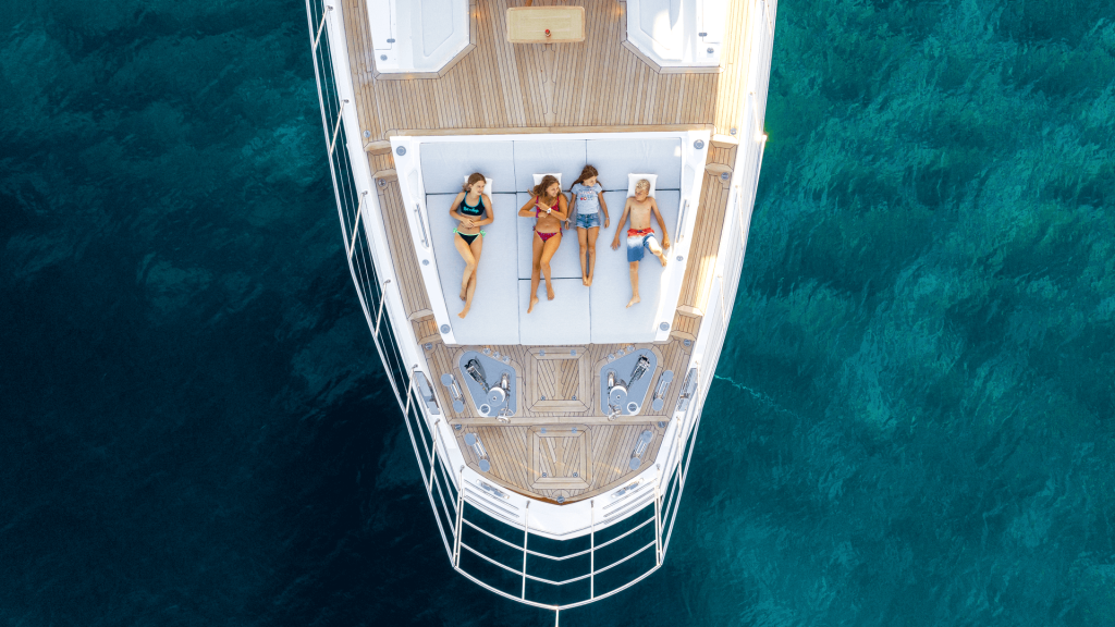dawo yacht charter guests relaxing on the foredeck