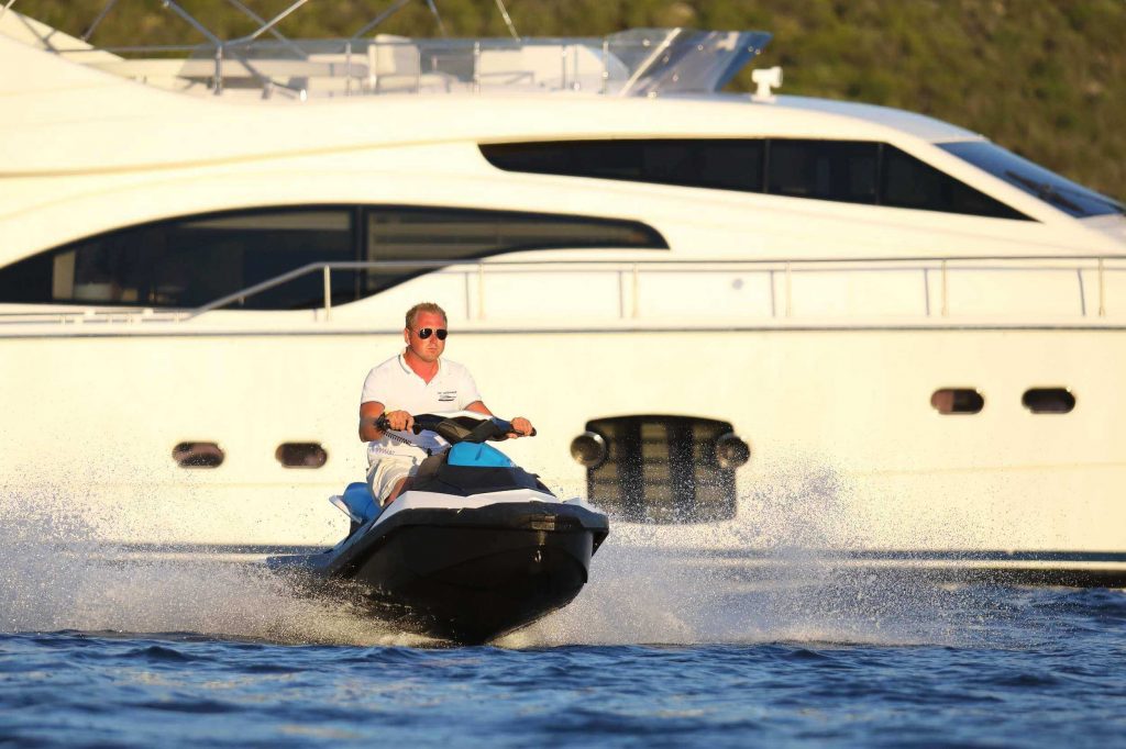 man on a jet ski by a dominique yacht