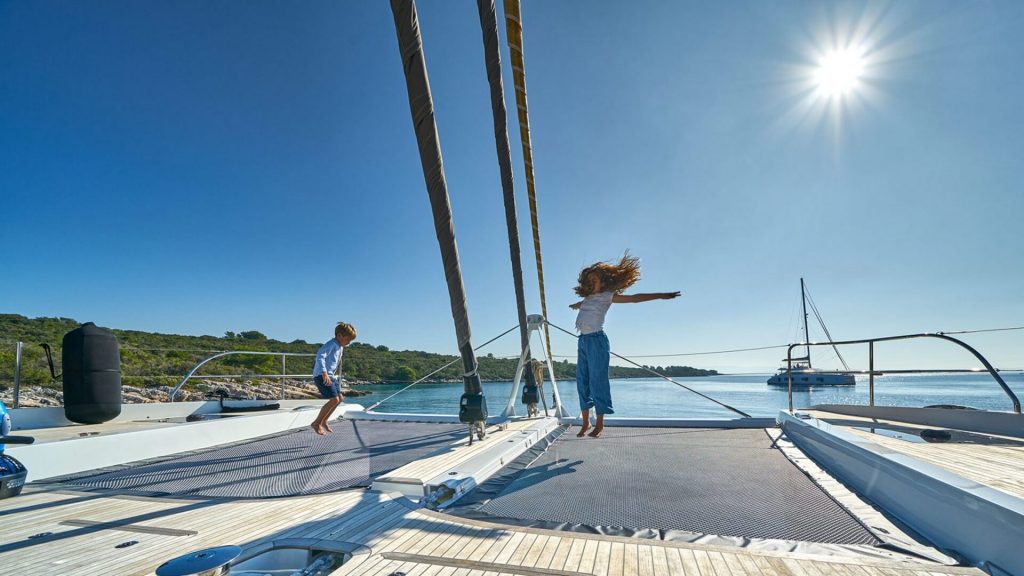 kids play on adriatic dragon catamaran yacht deck