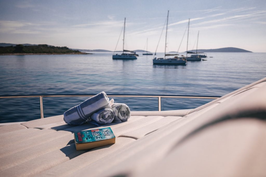 mowana yacht charter book and towels on the sunpads