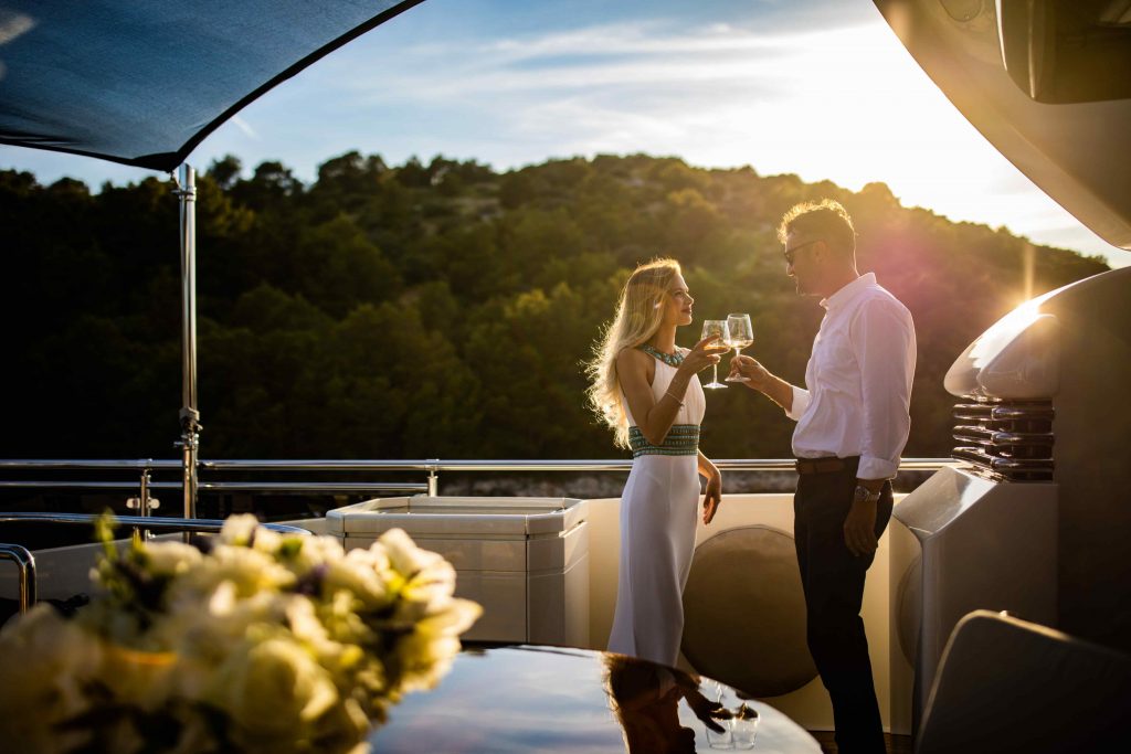 Novela yacht charter couple toasting on the deck