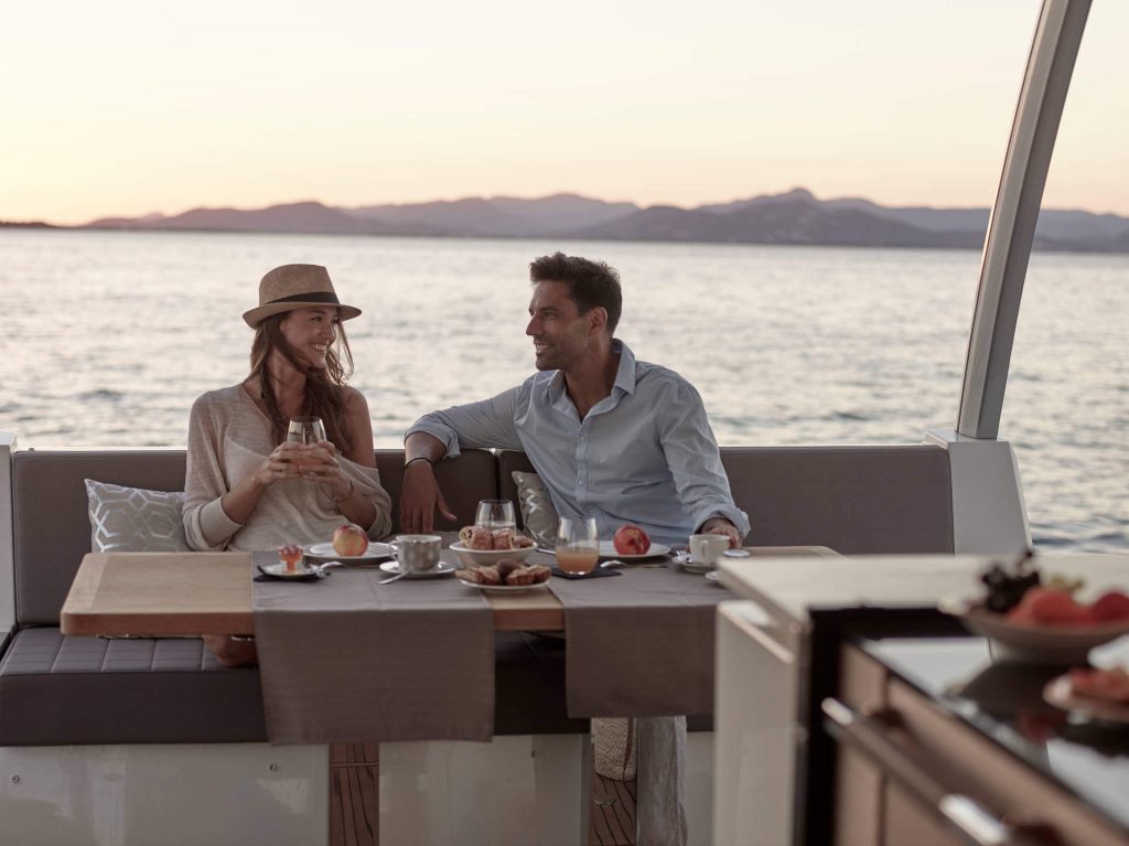couple on a yacht by the outdoor table
