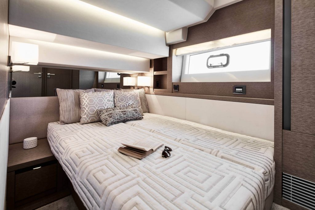 king size bed on a yacht in a master cabin