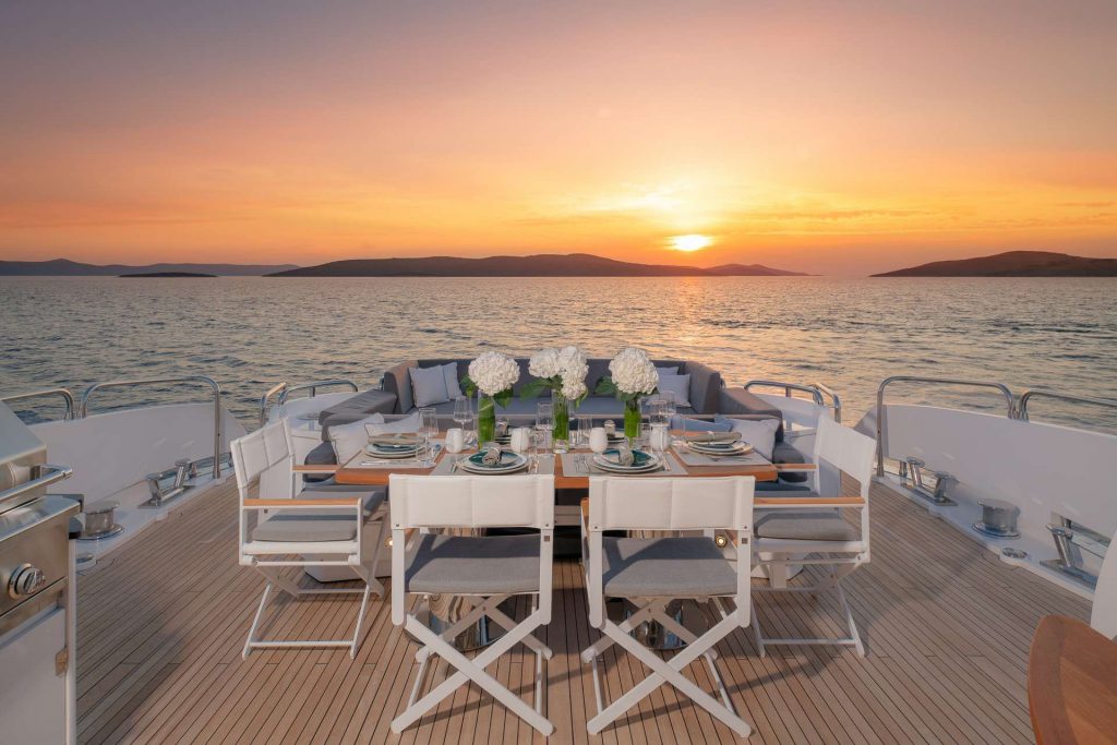 quantum yacht charter dining table at sunset