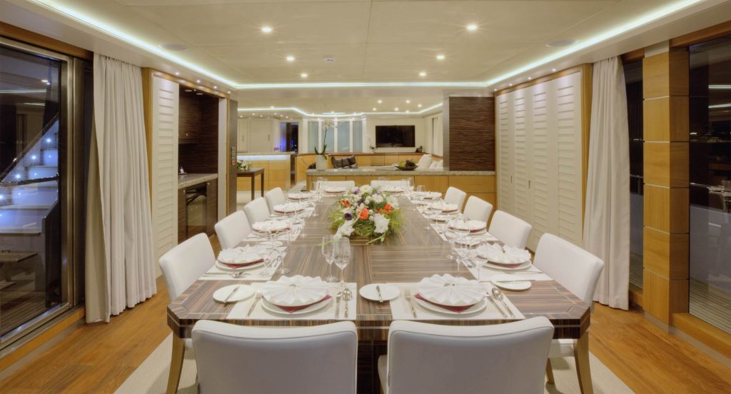 quaranta catamaran yacht charter main salon dining table prepared for a dinner