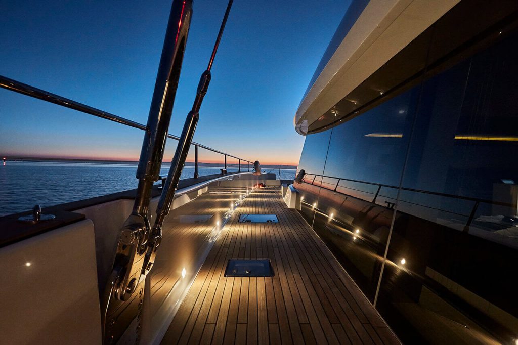 7x catamaran yacht side deck view by night