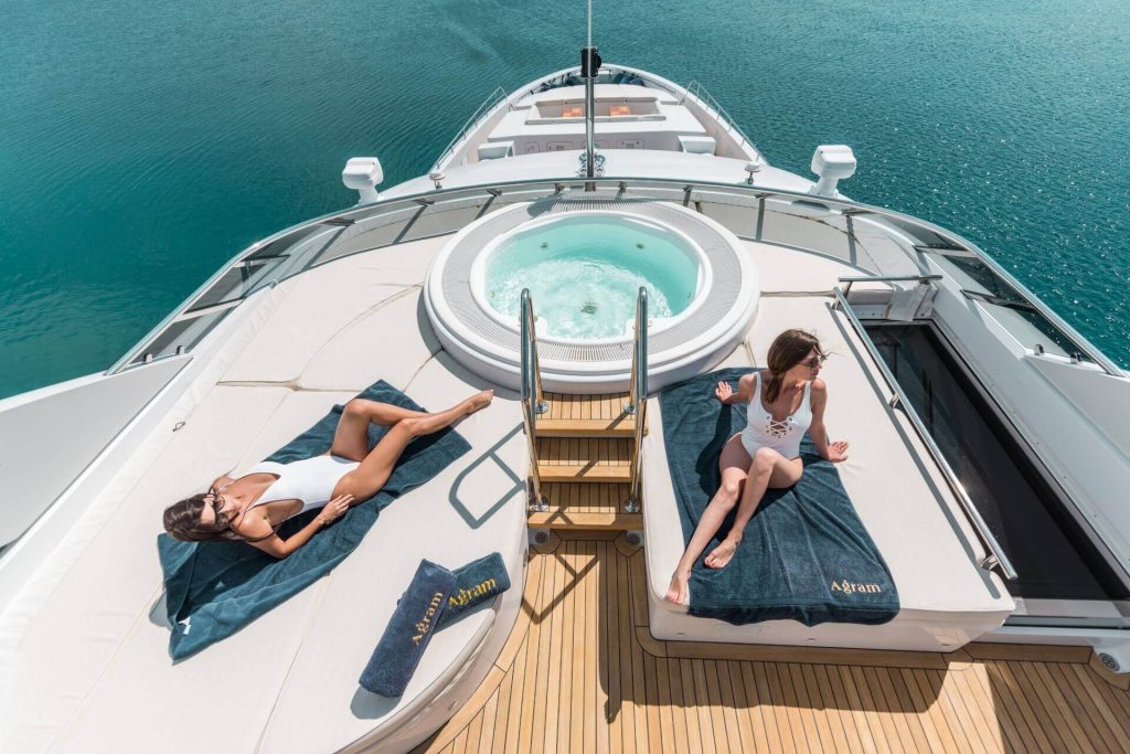 agram yacht charter girl sunbathing