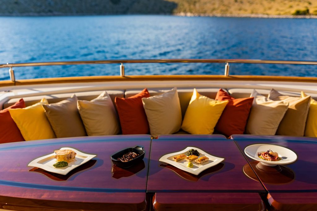 novela yacht charter food on the aft deck dining table