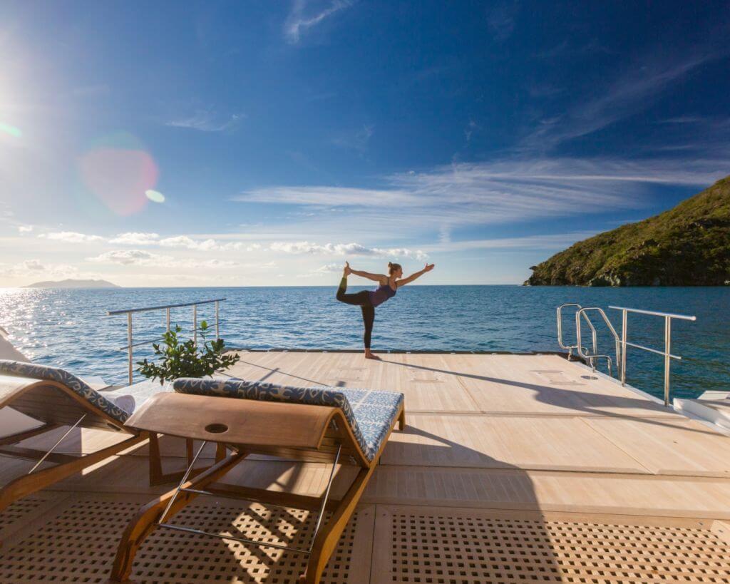 yacht yoga on a superyacht deck with a woman
