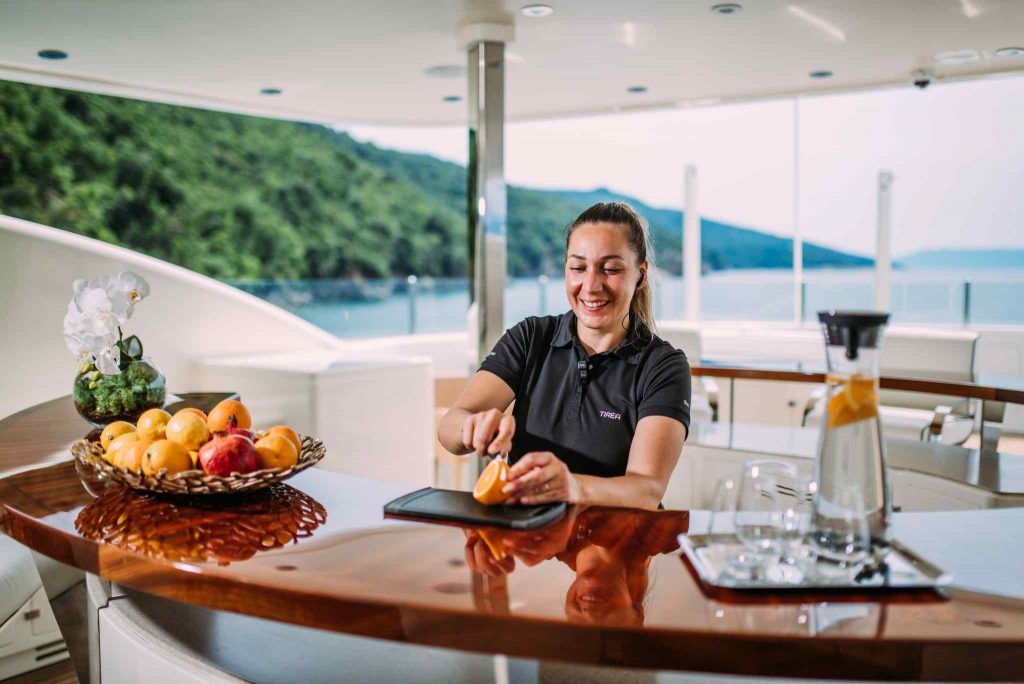 Tirea yacht charter stewardess preparing drinks