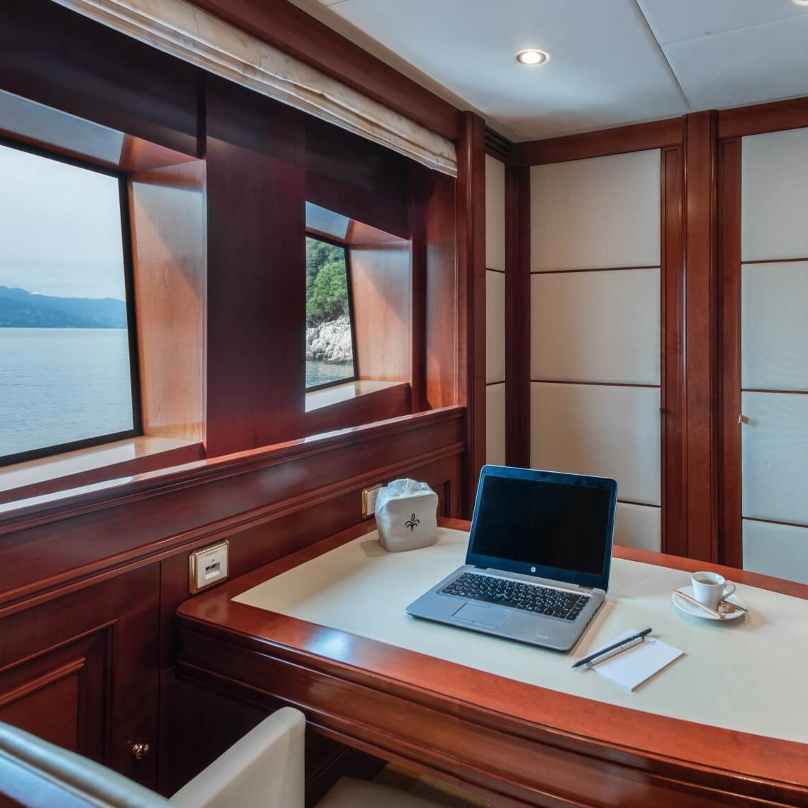 doing business on a yacht laptop on a desk