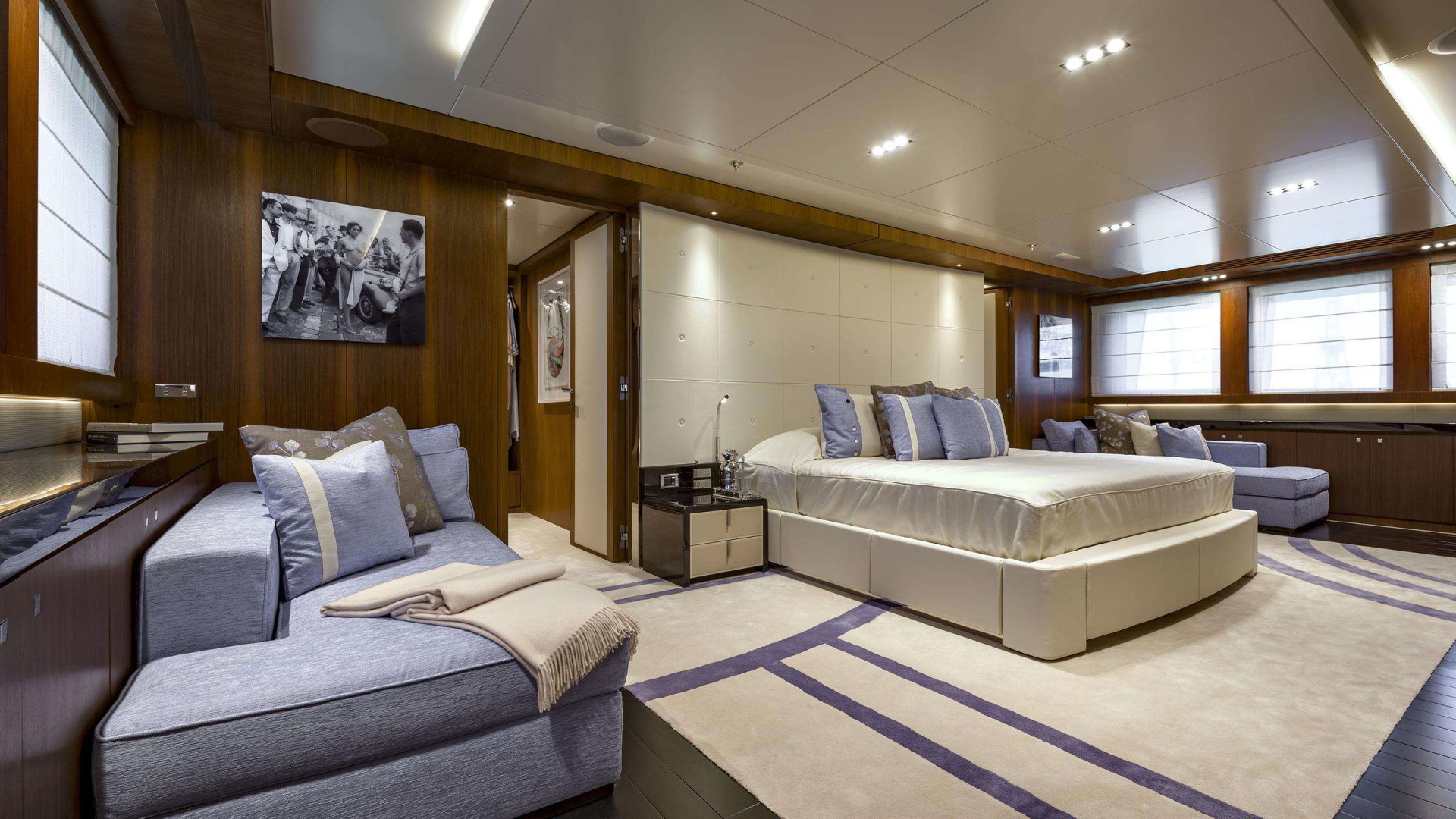 large superyacht cabin with a bed & a sofa