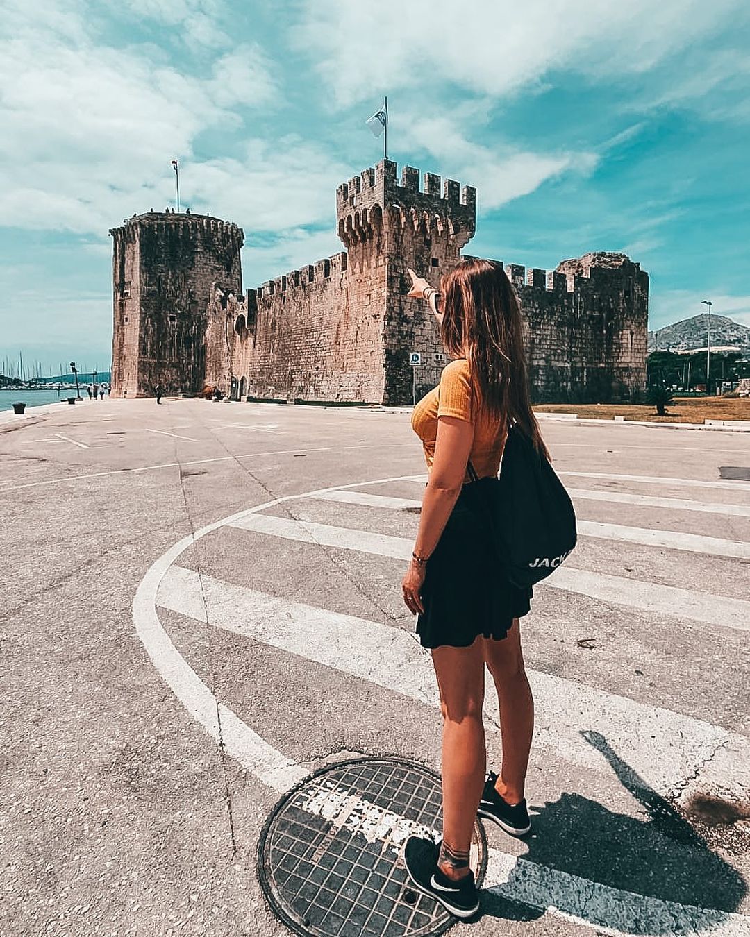 Yacht Charter in Trogir lady pointing to the fortress