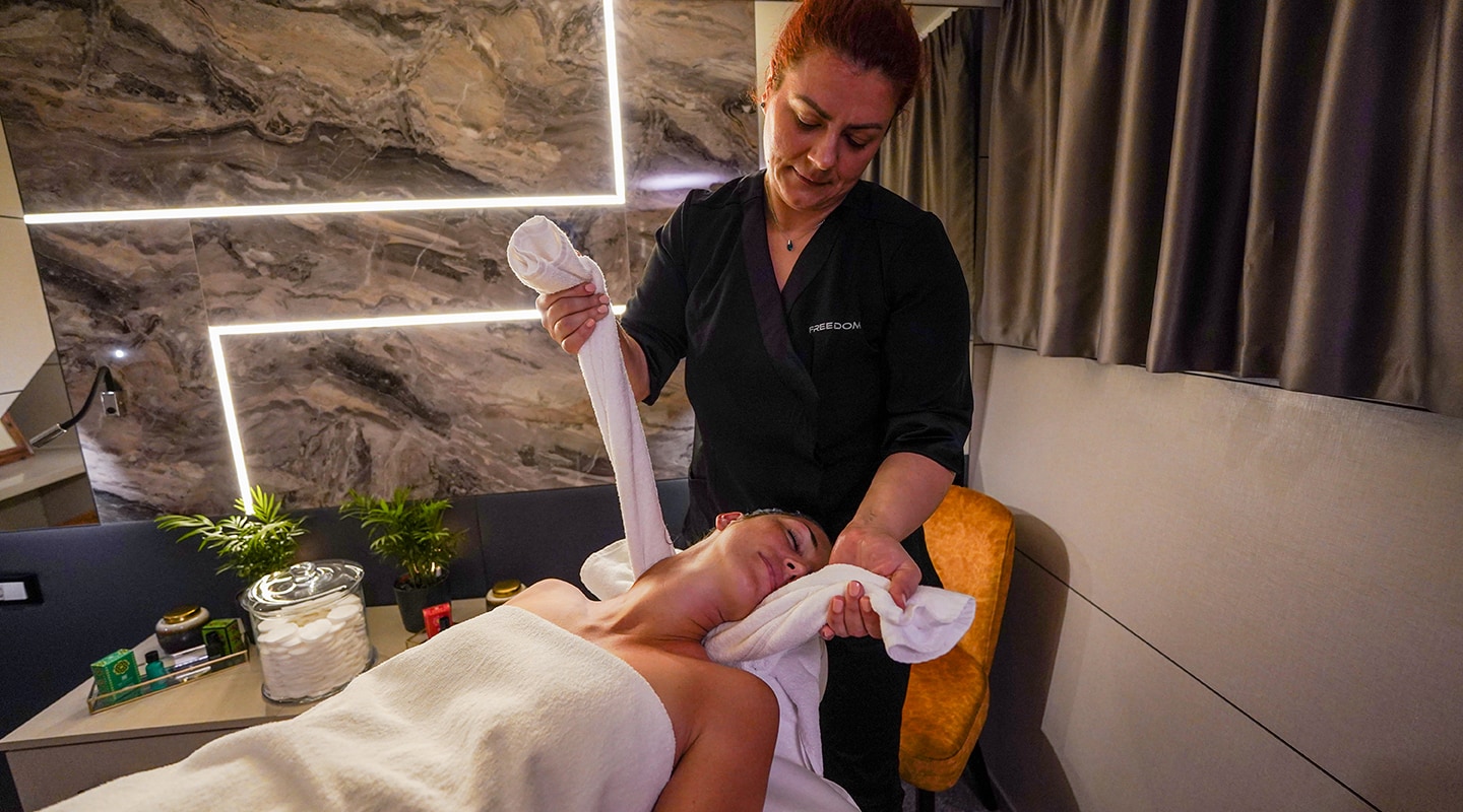 freedom yacht charter massage therapy crew member massaging a charter guests onboard freedom yacht