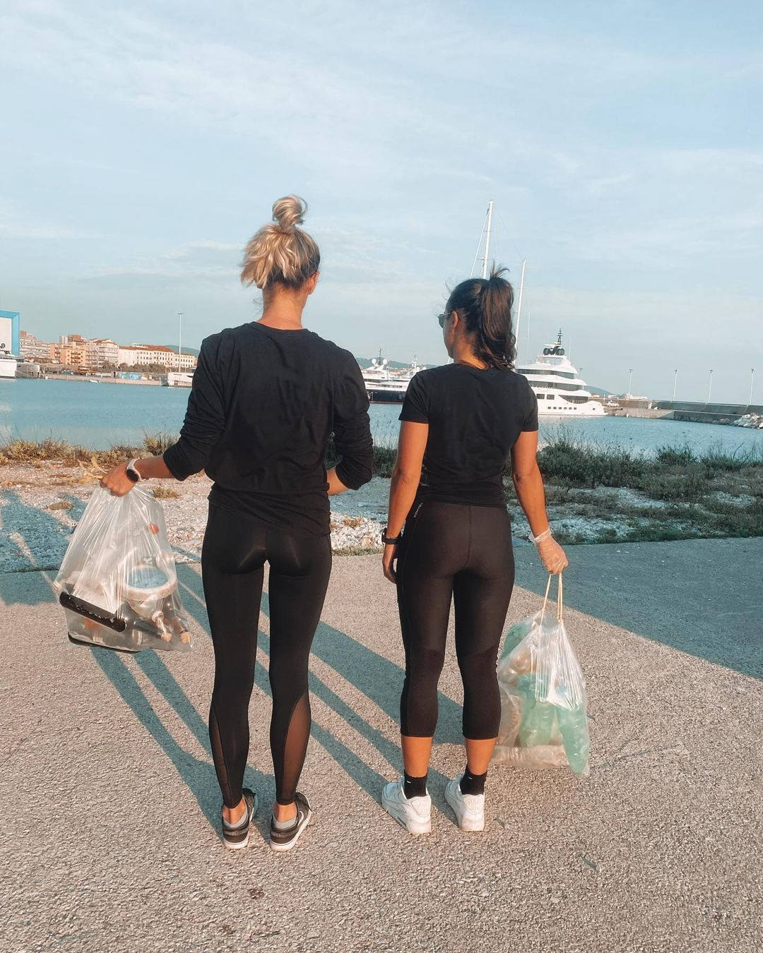 yacht charter support two ladies with trash bags