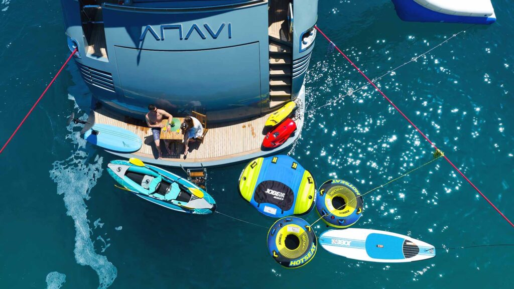guests with water toys on a yacht swimming platform