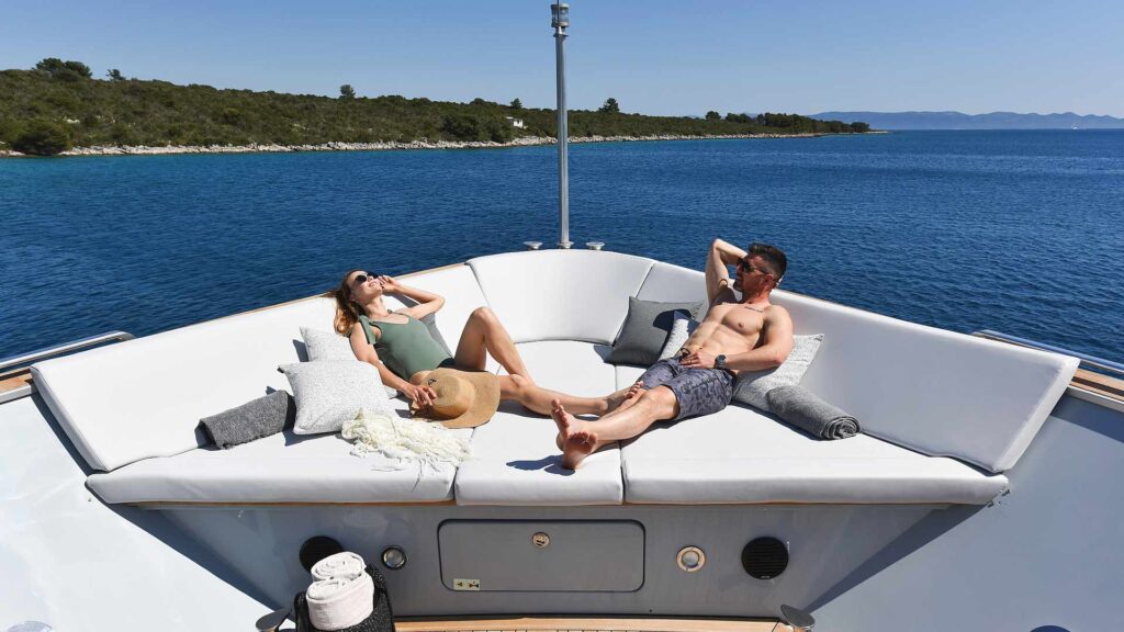 guests relaxing on the front deck lounge anavi yacht