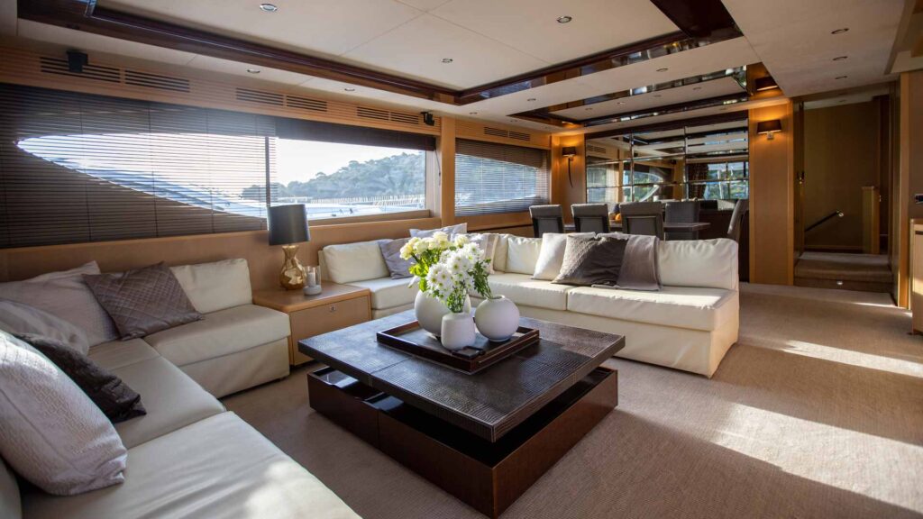 insieme yacht charter salon area with large c-shaped sofa