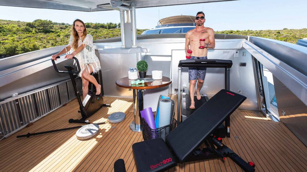 guests on a gym bicycle and a treadmill onboard anavi yacht