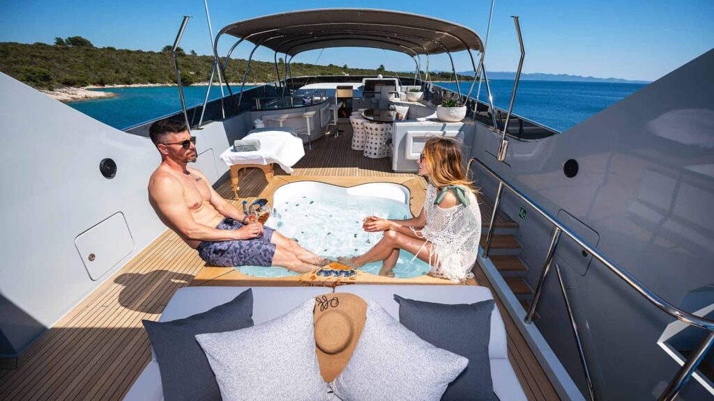 siting on the edge of a jacuzzi on a anavi yacht