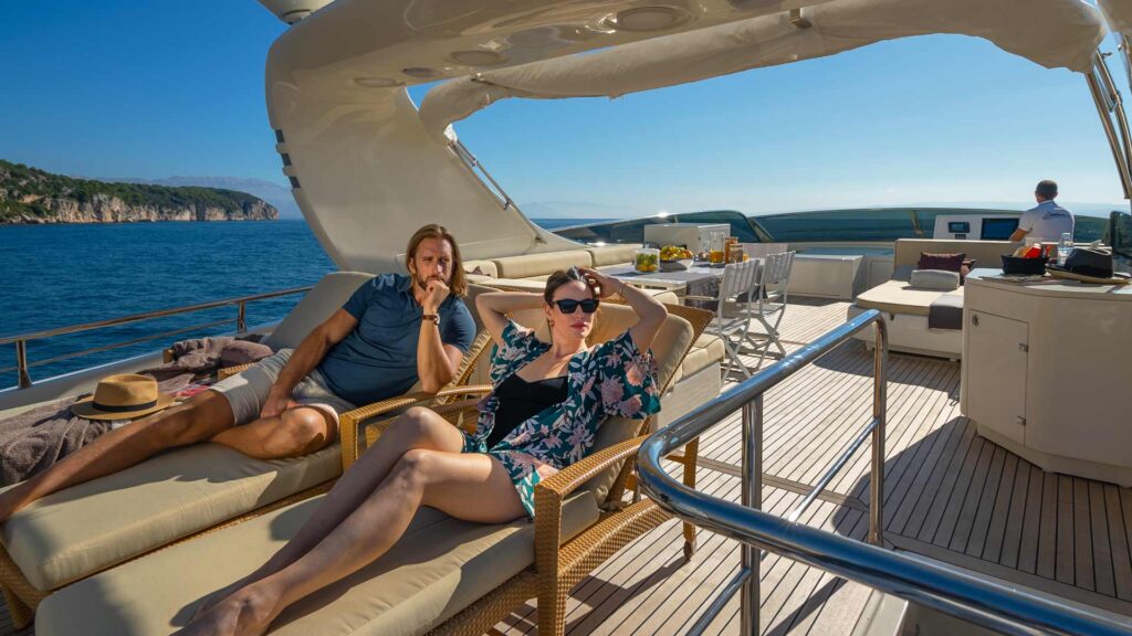 people on sun loungers on yacht deck
