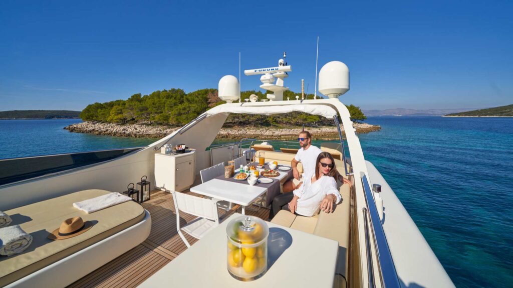 two people enjoying breakfast onboard a yacht
