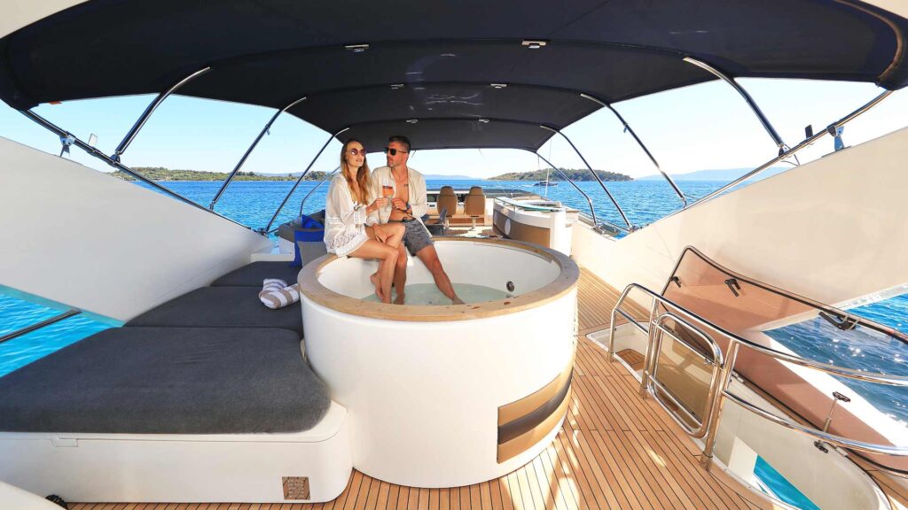 guests on the large jacuzzi on the yacht flybridge