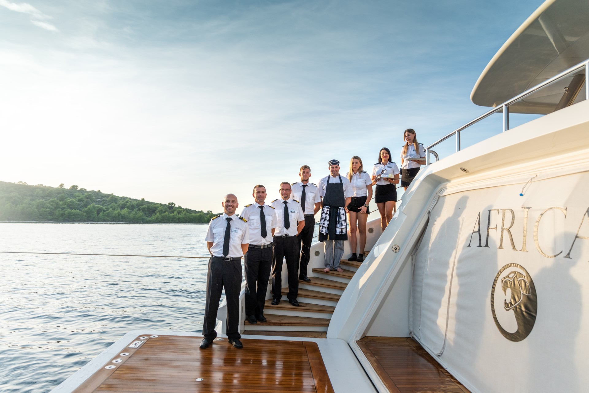 yacht crew posing on aft deck corporate yacht charter