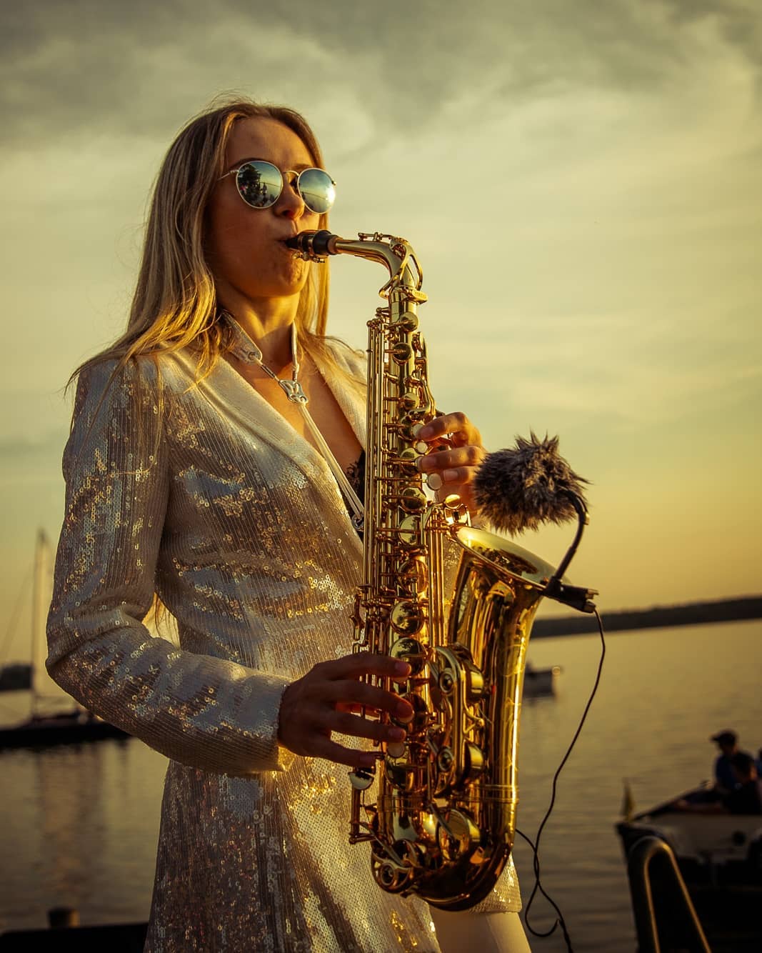 saxophone player with sea in background
