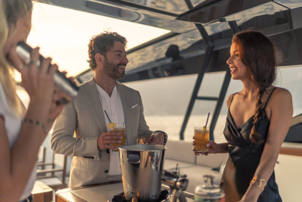 guests enjoying cocktails on the yacht sundeck