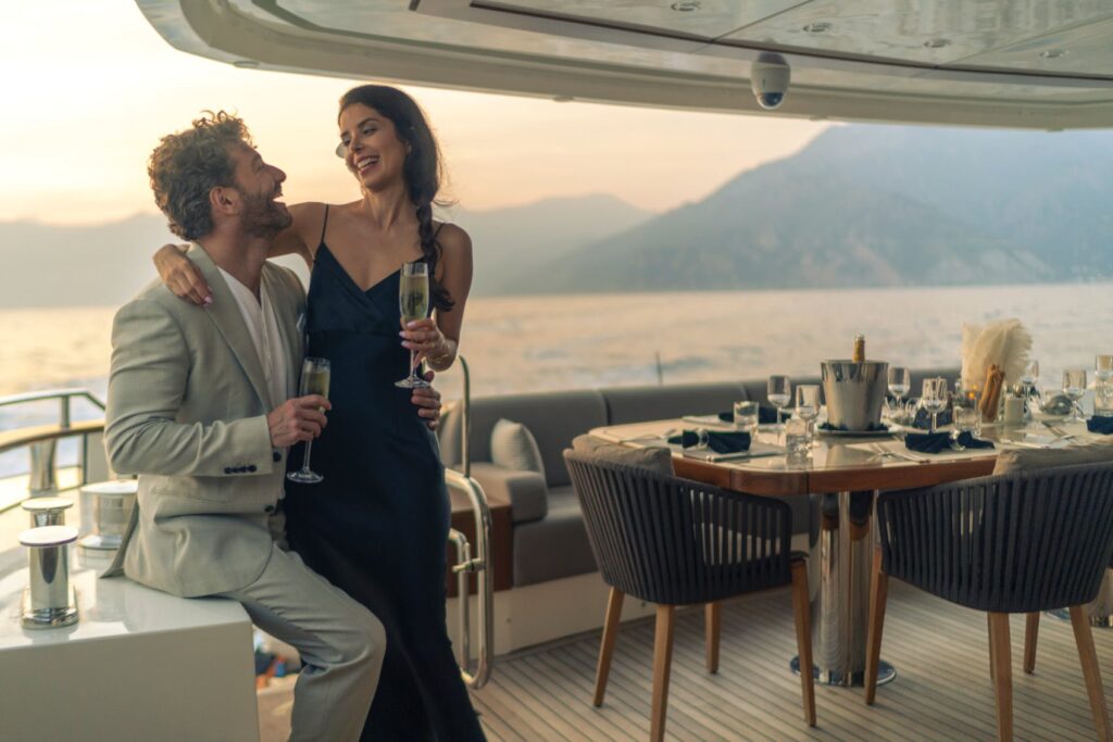 guests drinking champagne on the yacht aft deck