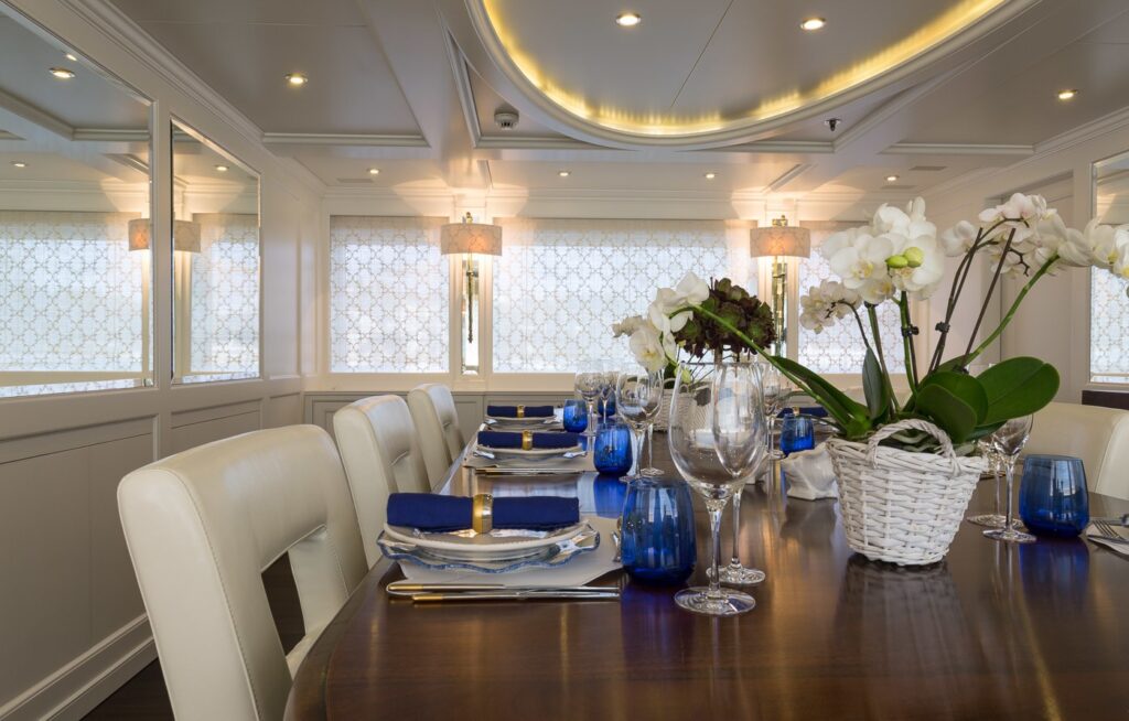 dining table yacht indoor with blue napkins