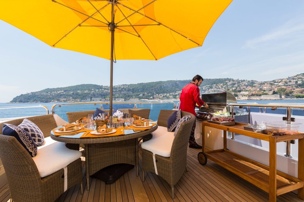 chef preparing food on the grill, yacht sundeck