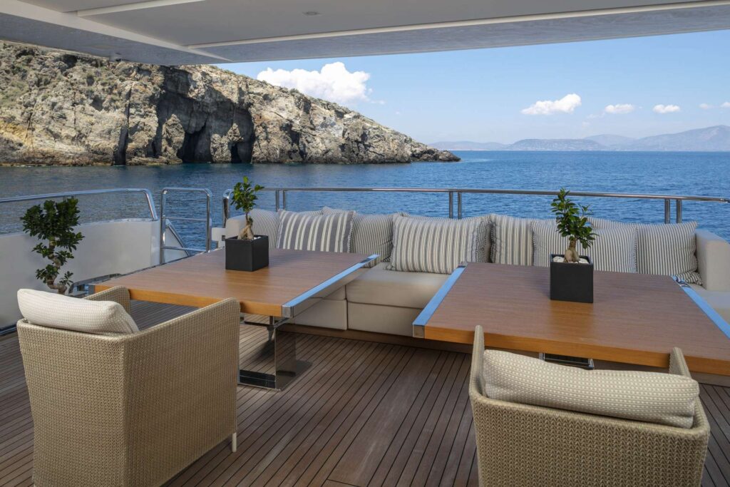 sofa with chairs and a table on the yacht aft deck