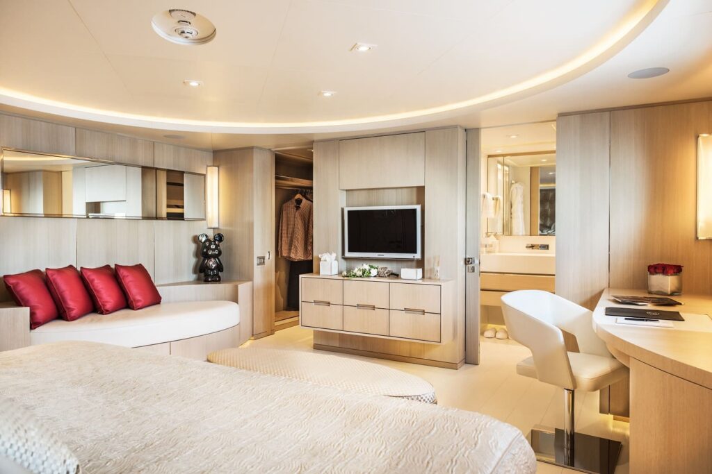 yacht cabin with a work desk, sofa & tv