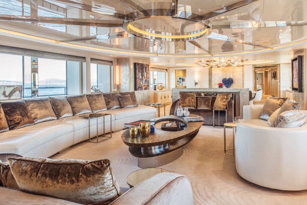 yacht salon area with wide sofas, silver cushions