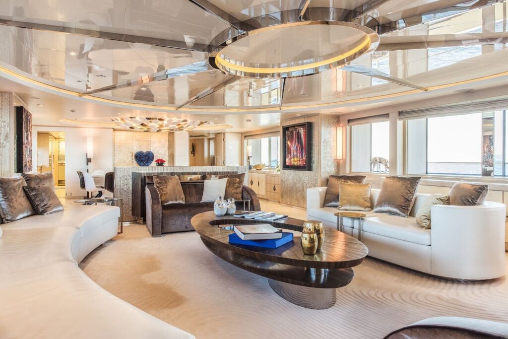 main salon area in a yacht, round black table in the middle