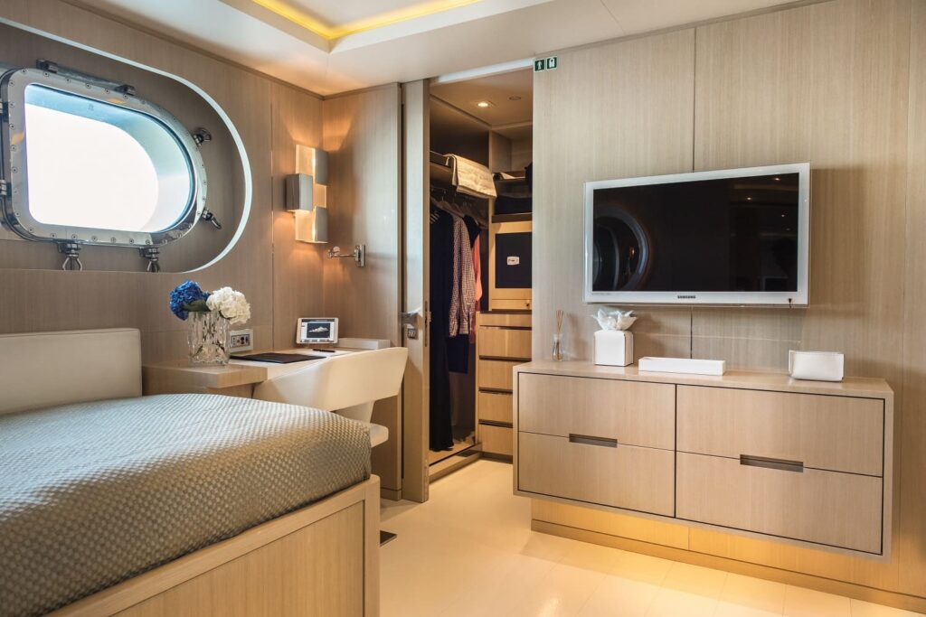 yacht cabin with a wide screen tv, walk in wardrobe