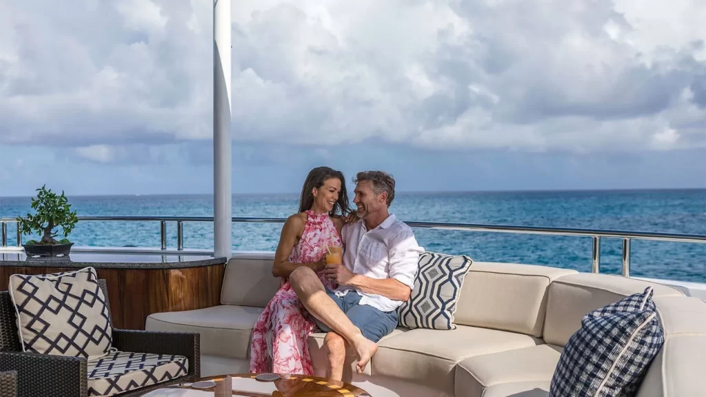 loon yacht charter couple on the upper deck lounge