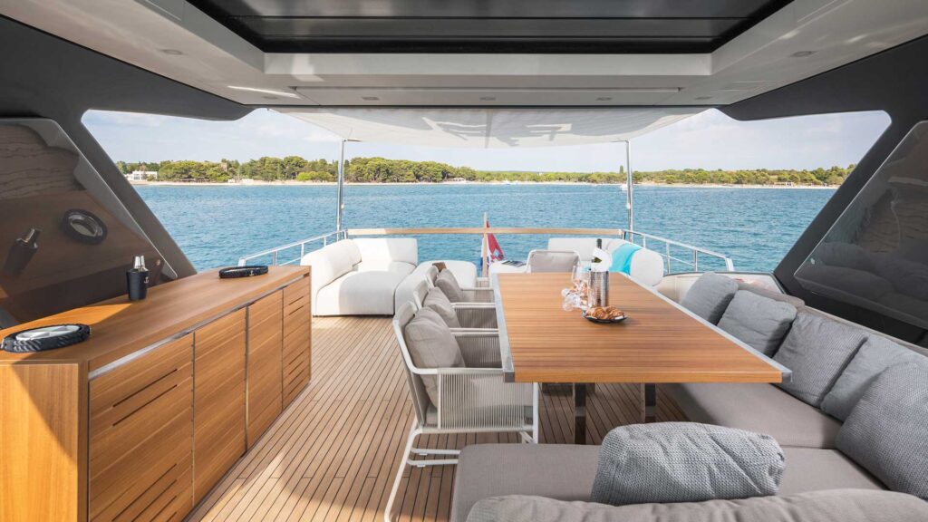 yacht sundeck with a bar, dining table, lounge sofas