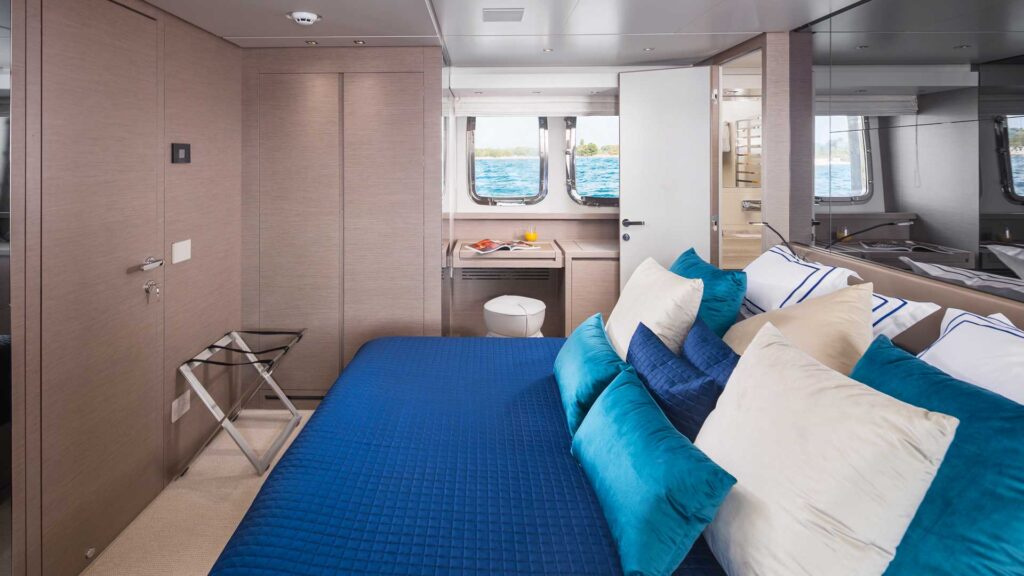 master suite onboard a yacht with 2 windows on the side