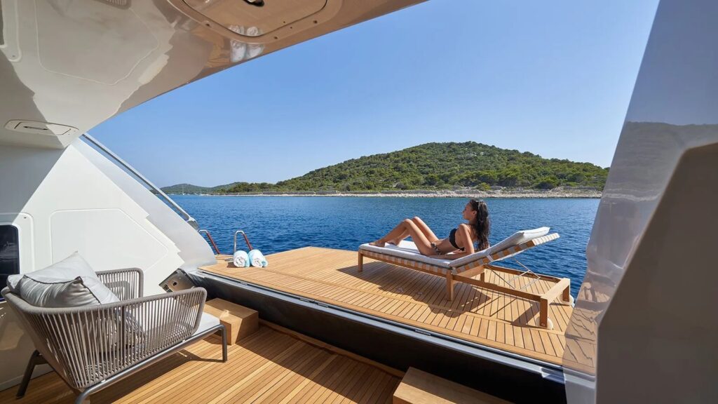 Nikita Yacht Charter lady relaxing on the swimming platform