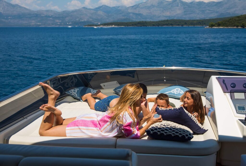 salt yacht charter family relaxing on sun pads