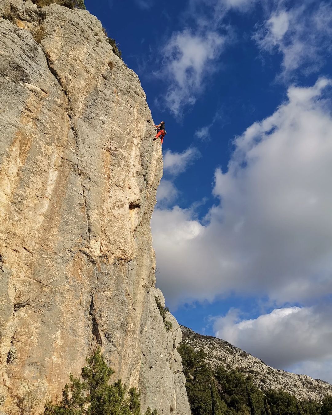 Rock climbing a steep rock face in Croatia