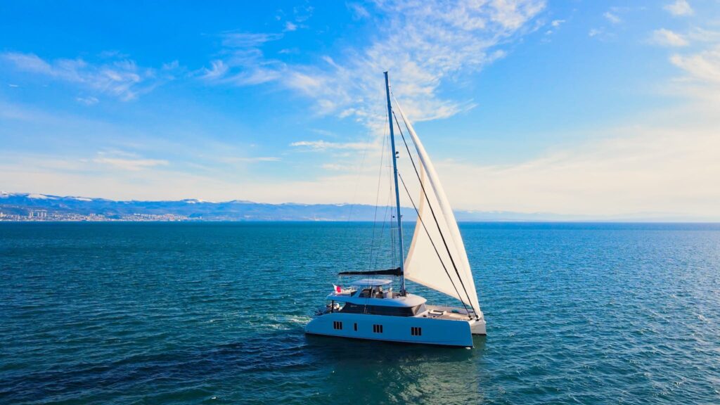 nala one catamaran yacht starboard side with sails