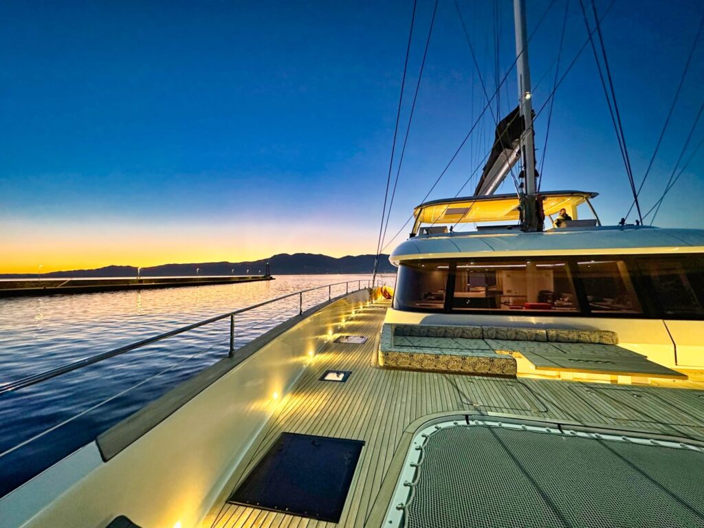 nala one catamaran yacht bow area at night