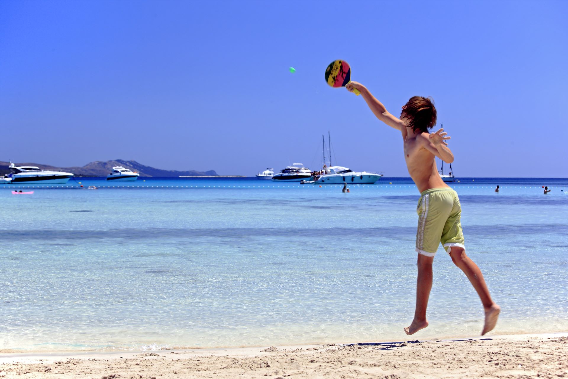 A child playing a game on a sandy beach - Sakarun in Croatia